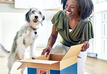 pet-parent-with-dog-with-hills-pet-food.jpg Happy dog and pet owner staff feeding Hill's
